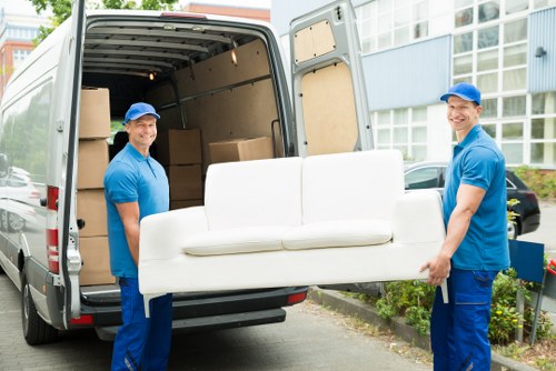 Man with van loading furniture for a move in Bow