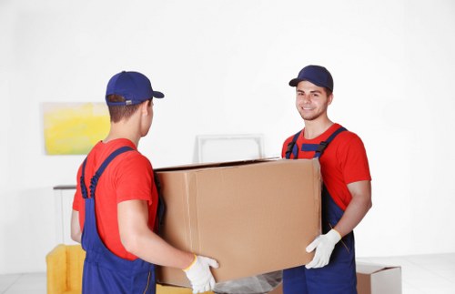Furniture pick-up team handling bulky household items in Bow