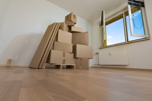 Office removals team preparing furniture for a move in Bow