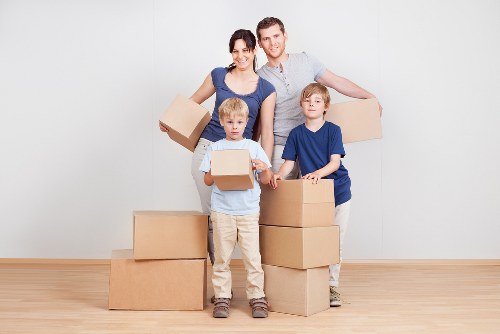 Removal team planning a house move in Bow with packed boxes and furniture
