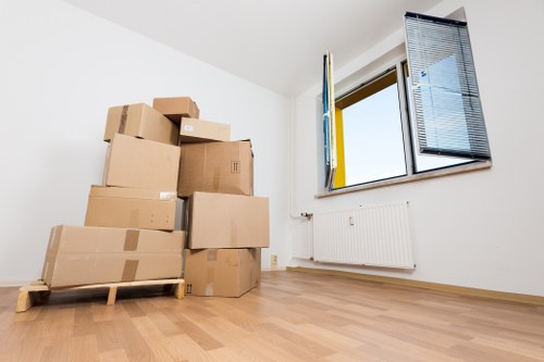 Moving team transporting boxes from a flat in Bow