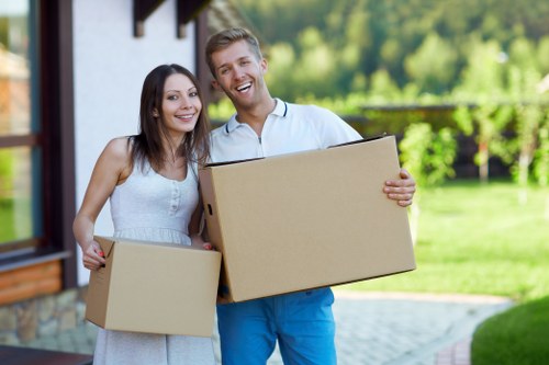 Two movers handling furniture for a Bow flat move