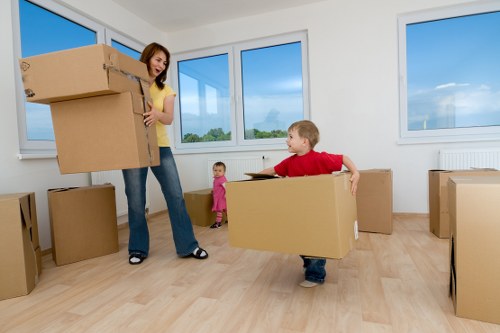 Team carrying furniture through a Bow apartment building