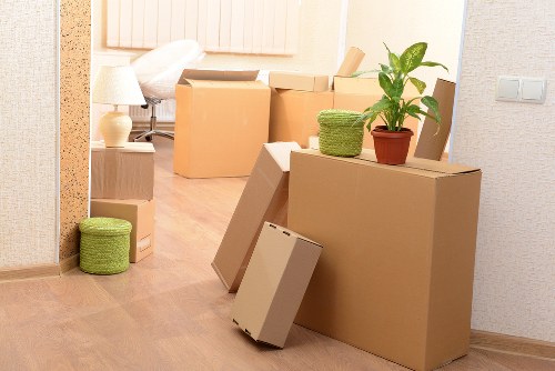 Professional movers loading household items for a Bow relocation